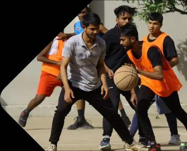 Young men playing basketball outdoors